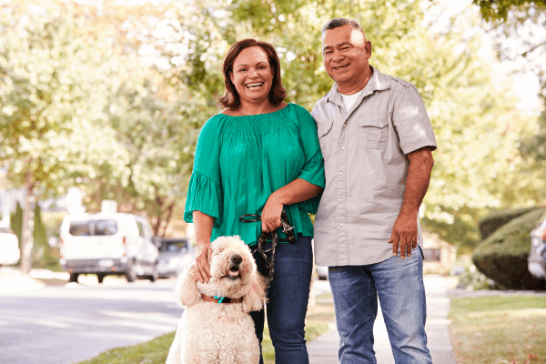 Man and Woman Smiling with Dog