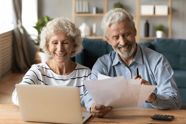 Man and Woman Sitting at Desk with Laptop Computer